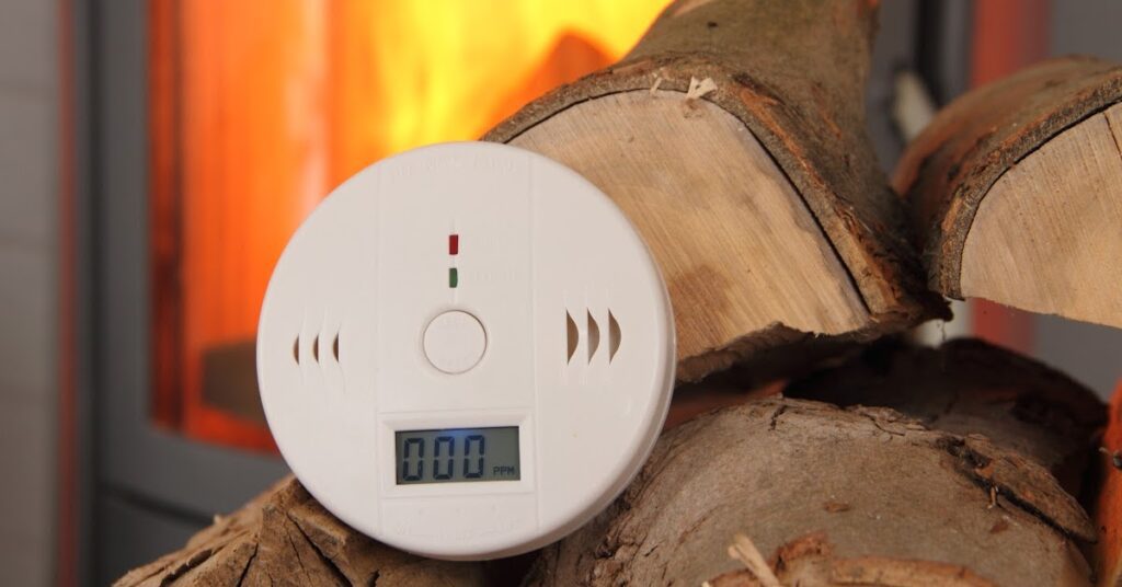 A carbon monoxyde detector on a wood pile
