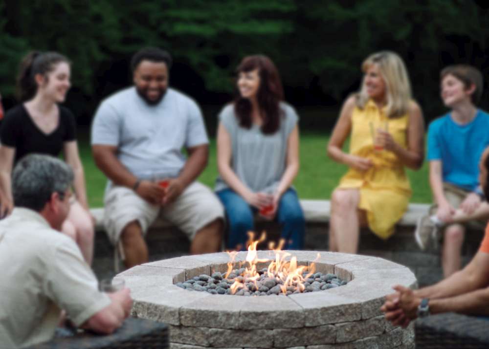 Family and Friends Gathered Around a Gas Firepit